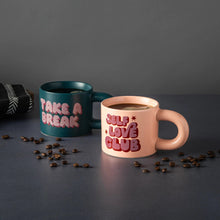 Stoneware mug pair with graphic text: dark green “Take a Break” and pink “Self Love Club”
