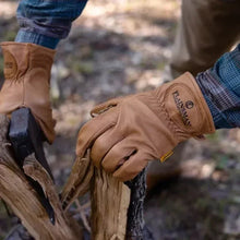 Brown cabretta leather gloves on hands, logo patch at wrist, stitched seams