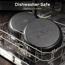 Black nonstick pans stacked in a dishwasher rack