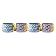 Stoneware teacup mugs with blue daisy and purple geometric prints, gold handles on display