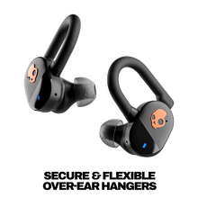 True wireless earbuds with flexible ear hooks, black earbuds with orange skull logo, angled views.