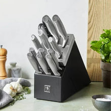 Self-sharpening knife block holding multiple gray knives with textured handles