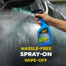 Hand holding Meguiar's Hybrid Ceramic Wax spray bottle with trigger nozzle on car paint