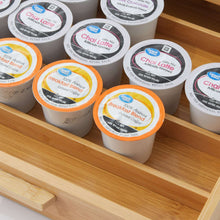 Natural bamboo coffee pod organizer filled with assorted k-cups in open tray