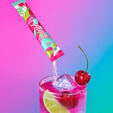 Cherry twist energy drink mix stick pouring into glass with ice and lime