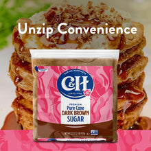Dark brown sugar pouch centered in front of pancakes, pink label visible