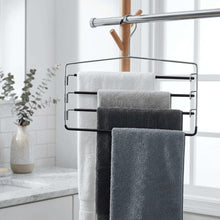 Metal 4-tier pant and skirt hanger with four folded towels on tiers and top hook