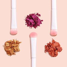 Makeup brushes with soft pink bristles, with purple and brown pigment on bristles