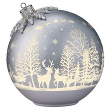 Single gold Christmas ornament close-up with woodland deer and tree pattern