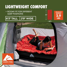 Rectangular sleeping bag in tent with red blanket and gray quilted top
