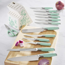 Assorted knives with mint handles shown on a wooden board, with matching kitchen shears