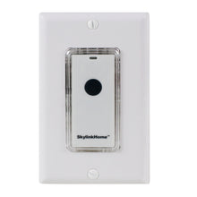 White wall switch faceplate with snap-on remote in clear case and black button.