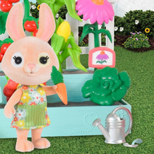 Bunny figure with gardening apron beside mini planter with vegetables and a watering can