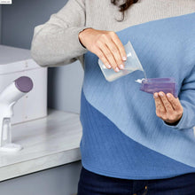 Handheld garment steamer with removable water tank and purple nozzle accents