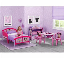Kids toddler bed with pink Minnie Mouse bedding, matching headboard and footboard