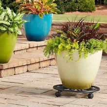 Black plant caddy with lattice top under a cream planter with greenery