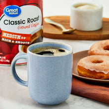 Ground coffee bag with Classic Roast label and a cup of brewed coffee