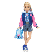 Disney Ily fashion doll standing with pink sleeves hoodie, denim shorts, and blue shoes.