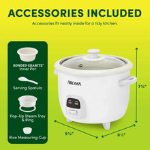 White rice cooker with serving spatula, steam tray, and measuring cup accessories