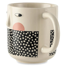 Stoneware mug with cheeky face design, cream body, black polka-dot rectangle and handle