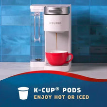 K-Cup pod brewer with red coffee mug, Seattle’s Best Coffee serving