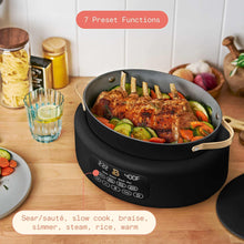 Black electric multi-cooker pot with lid, cooking vegetables and herbs inside