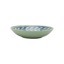 Green dinner bowl with blue leaf-pattern rim and light green interior