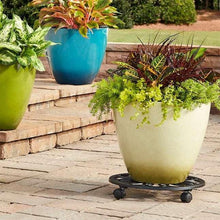 Black plant caddy with lattice top under a cream planter with green plants