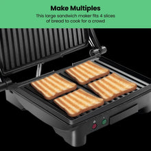4-slice panini press grill with four toast pieces on ridged nonstick plates