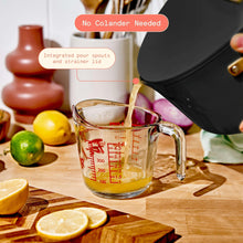Black stock pot spout with integrated pour and strainer lid; measure cup under pour