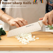 Kitchen knife with white handle and speckled blade chopping onions on a wooden cutting board