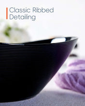 Black ribbed oval bowl with curved rim and glossy inner surface
