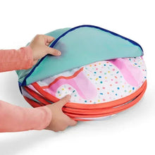 Folded fabric tent in a round storage bag with blue top and pink dotted lining