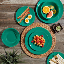 Dark green melamine plates and bowls arranged for serving.