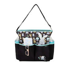 Monkey-print diaper tote bag with open top and storage compartments, black and teal trim