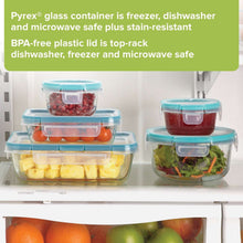 Stacked clear glass meal prep containers with blue lids, multiple shapes