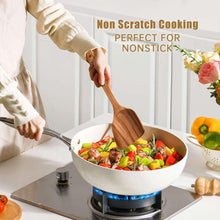 Wooden cooking spatula stirring food in a skillet for nonstick cookware