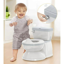 White toddler potty training toilet with gray seat lid and paper roll, shown with a child