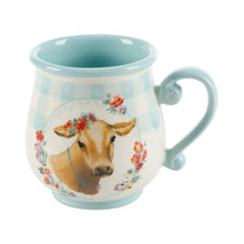 Stoneware mug with light blue glaze, cow illustration, curved side handle