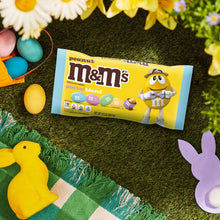 Peanut M&M's pastel blend milk chocolate candy bag on green grass with eggs.
