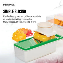 Mandoline slicer tray with green insert holding sliced vegetables.