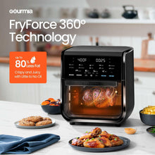 Black air fryer oven with front window showing roasted chicken, countertop design