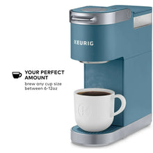 Evening teal single-serve coffee maker with mug under dispensing spout