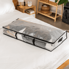 Clear under-bed storage bag with black handles and zipper, laid flat