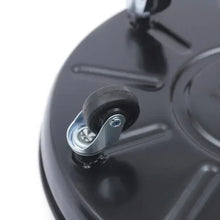 Close-up of a caster wheel attached to a black round plant caddy tray
