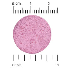 Purple chewable tablet with size measurement marks.