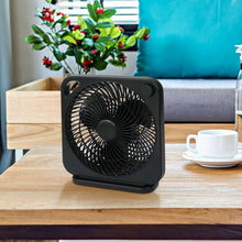Black portable table fan with front grille, top handle, and base