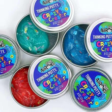 Thinking putty tins with teal, blue, and red putty inside round metal lids