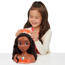 Moana styling head toy while a child styles the hair