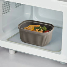 Grey ribbed plastic snack container with lid and portioned meal